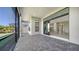 Screened-in lanai featuring brick pavers and sliding glass doors to the home's interior at 4621 Mondrian Ct, Sarasota, FL 34240