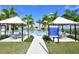 Community pool area with pool rules, shaded seating, palm trees, and well-maintained landscaping at 4621 Mondrian Ct, Sarasota, FL 34240