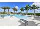 Community pool featuring a modern bench, lounge chairs and palm trees at 4621 Mondrian Ct, Sarasota, FL 34240