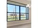 Large windows with a view of a serene pond and neighboring houses at 4621 Mondrian Ct, Sarasota, FL 34240
