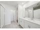 Modern bathroom featuring double vanity, white cabinets, tile flooring, and glass shower at 31629 Malbec Dr, Brooksville, FL 34602