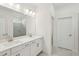 Modern bathroom with double vanity, white cabinets, quartz countertop, and tile shower at 466 Sun Chaser Dr, Nokomis, FL 34275