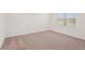 A bedroom with neutral carpet, white walls and trim and a window with blinds at 466 Sun Chaser Dr, Nokomis, FL 34275