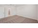 Empty bedroom with neutral carpet, ensuite bath, and a door at 466 Sun Chaser Dr, Nokomis, FL 34275