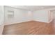 Bright living room with wood-look floors and neutral walls at 466 Sun Chaser Dr, Nokomis, FL 34275