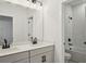 Stylish bathroom showcasing double sinks, quartz countertops, and matte black fixtures at 474 Sun Chaser Dr, Nokomis, FL 34275