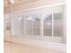 Sunroom with vertical blinds on large windows, tile floors, and access to the backyard at 12908 Cattail Shore Ln, Riverview, FL 33579