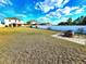 Backyard view with a brick fire pit and expansive grassy area surrounded by a fence at 109 Tierra Verde Way, Bradenton, FL 34212