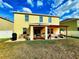 Spacious backyard showing the house's exterior and a pergola-covered seating area at 109 Tierra Verde Way, Bradenton, FL 34212