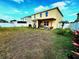 Backyard with a pergola, grassy area, and a view of the two-story home at 109 Tierra Verde Way, Bradenton, FL 34212