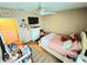 Cozy bedroom with neutral walls, ceiling fan, dresser, and bed with decor at 109 Tierra Verde Way, Bradenton, FL 34212
