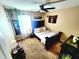 Well-lit bedroom with a black bed frame, decor, houseplants, and an area rug at 109 Tierra Verde Way, Bradenton, FL 34212