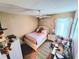 Bedroom with a cozy bed, ceiling fan, carpet flooring, and a large window at 109 Tierra Verde Way, Bradenton, FL 34212