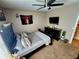 Bedroom featuring a gray bed set, a TV on a dresser, and simple decor at 109 Tierra Verde Way, Bradenton, FL 34212