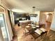 Open-concept dining area with wood-look floors, access to the kitchen, and a sliding glass door at 109 Tierra Verde Way, Bradenton, FL 34212