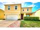 Two-story home with a well-manicured lawn, brick walkway, attached garage, and welcoming front porch at 109 Tierra Verde Way, Bradenton, FL 34212