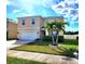 Two-story home featuring a palm tree in the front yard, a white garage door, and a tidy lawn at 109 Tierra Verde Way, Bradenton, FL 34212