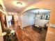 Open-concept living room with wood-look flooring, neutral walls, and an arched entryway at 109 Tierra Verde Way, Bradenton, FL 34212