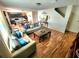 Cozy living room featuring stylish sofas, a decorative mirror, and beautiful hardwood floors at 109 Tierra Verde Way, Bradenton, FL 34212