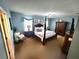 Spacious main bedroom featuring a four-poster bed, carpet flooring, and ample natural light at 109 Tierra Verde Way, Bradenton, FL 34212