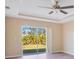 Bedroom with a sliding glass door to backyard, a ceiling fan, and neutral walls at 14248 Salvatierra Ln, Port Charlotte, FL 33981