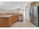 Kitchen features stainless steel appliances, wood cabinets, and an eat-in bar at 14248 Salvatierra Ln, Port Charlotte, FL 33981