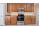 Functional kitchen showcases stainless steel oven and microwave with ample wood cabinetry at 14248 Salvatierra Ln, Port Charlotte, FL 33981