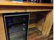 Custom wooden bar featuring a built-in mini refrigerator and a rustic aesthetic at 718 New York St, Clearwater, FL 33756