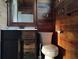 Rustic bathroom featuring wood paneling, a dark vanity with marble countertop, and modern fixtures, creating a cozy ambiance at 718 New York St, Clearwater, FL 33756