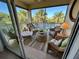 Screened-in balcony with wicker furniture, tropical views, and tiled floor, perfect for relaxing at 3233 Purple Martin Dr # 121, Punta Gorda, FL 33950