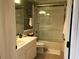 Well-lit bathroom with a white vanity, framed mirror, and shower with clear glass door at 3233 Purple Martin Dr # 121, Punta Gorda, FL 33950