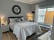 Comfortable bedroom featuring a queen-sized bed, bright windows, and a neutral color scheme at 3233 Purple Martin Dr # 121, Punta Gorda, FL 33950