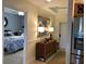 Hallway view with a glimpse into the bedroom, showcasing tiled floors, decorative lighting, and a glimpse into the kitchen at 3233 Purple Martin Dr # 121, Punta Gorda, FL 33950