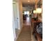 Inviting entryway featuring tile flooring, a wooden console table with lamps, and a view into the living spaces at 3233 Purple Martin Dr # 121, Punta Gorda, FL 33950