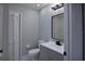 Modern bathroom featuring a gray vanity, framed mirror and decorative light fixture at 1147 Yachtsman Ln, Punta Gorda, FL 33983