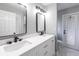 Modern bathroom featuring a double vanity with black fixtures, a large mirror, and a walk-in shower at 1147 Yachtsman Ln, Punta Gorda, FL 33983