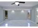 Bright bedroom with white marble floors, a ceiling fan, and abundant natural light from two large windows at 1147 Yachtsman Ln, Punta Gorda, FL 33983