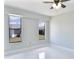 Bright bedroom with two windows, pristine tile floors and ceiling fan at 1147 Yachtsman Ln, Punta Gorda, FL 33983