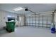 Spacious two-car garage with door, window, and shelving space at 1147 Yachtsman Ln, Punta Gorda, FL 33983
