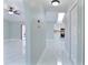 Bright hallway with tile floors, skylight, and neutral walls, connecting the living spaces at 1147 Yachtsman Ln, Punta Gorda, FL 33983
