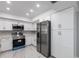Modern kitchen with white cabinetry, stainless steel appliances, and countertops at 1147 Yachtsman Ln, Punta Gorda, FL 33983