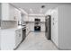 Modern kitchen featuring white cabinets, quartz countertops, stainless steel appliances, and tile flooring at 1147 Yachtsman Ln, Punta Gorda, FL 33983