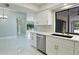 Kitchen view shows updated cabinetry, stainless steel appliances, tile floors, and open access to the living space at 1147 Yachtsman Ln, Punta Gorda, FL 33983
