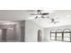 Spacious living room with high ceilings, ceiling fans, natural light, and tile flooring at 1147 Yachtsman Ln, Punta Gorda, FL 33983