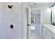 Modern walk-in shower with marble-look tiling and stylish fixtures connects seamlessly with the bathroom vanity at 1147 Yachtsman Ln, Punta Gorda, FL 33983