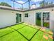 Backyard with turf and brick accents, providing a low-maintenance and visually appealing outdoor space at 2956 Laurel Ct, Dunedin, FL 34698