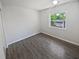 Bedroom features a window providing natural light and vinyl floors at 2956 Laurel Ct, Dunedin, FL 34698