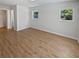 Spacious bedroom with wood-look floors, white walls, and natural light from two windows at 2956 Laurel Ct, Dunedin, FL 34698