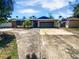 Charming single-story brick home featuring a spacious driveway and attached two-car garage at 2956 Laurel Ct, Dunedin, FL 34698