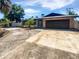 Charming single-story brick home featuring a spacious driveway and attached two-car garage at 2956 Laurel Ct, Dunedin, FL 34698